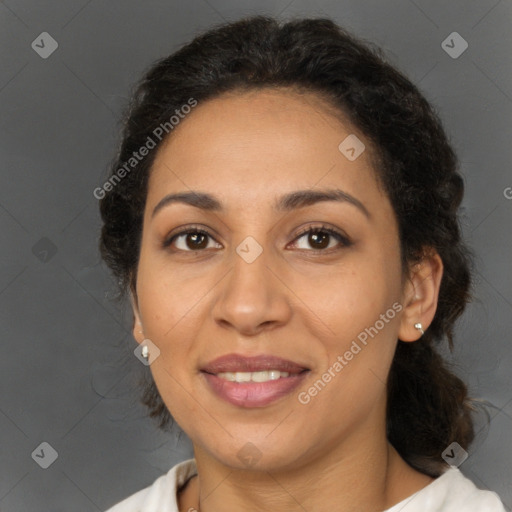 Joyful latino adult female with medium  brown hair and brown eyes