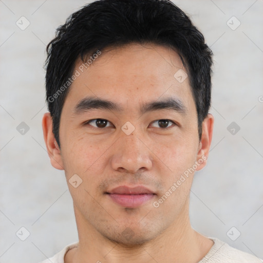 Joyful asian young-adult male with short  black hair and brown eyes