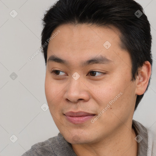 Joyful asian young-adult male with short  brown hair and brown eyes