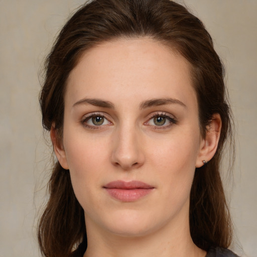 Joyful white young-adult female with medium  brown hair and green eyes