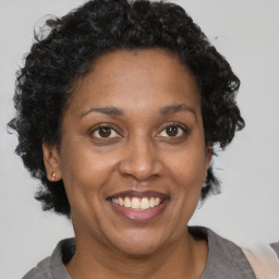 Joyful black adult female with short  brown hair and brown eyes