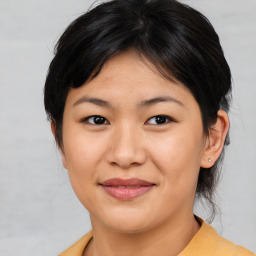 Joyful asian young-adult female with medium  brown hair and brown eyes