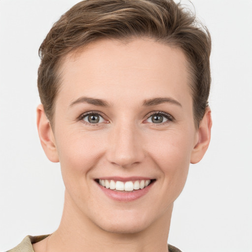 Joyful white young-adult female with short  brown hair and grey eyes