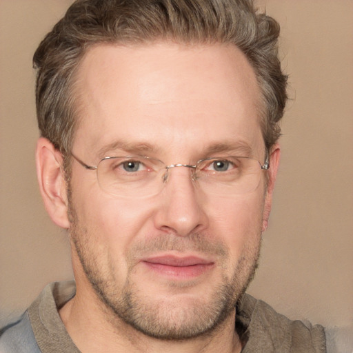 Joyful white adult male with short  brown hair and grey eyes