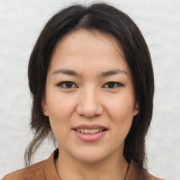 Joyful asian young-adult female with medium  brown hair and brown eyes