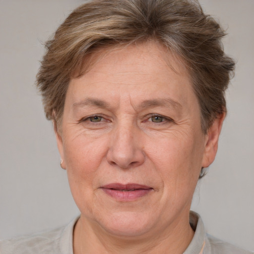 Joyful white middle-aged female with short  brown hair and grey eyes