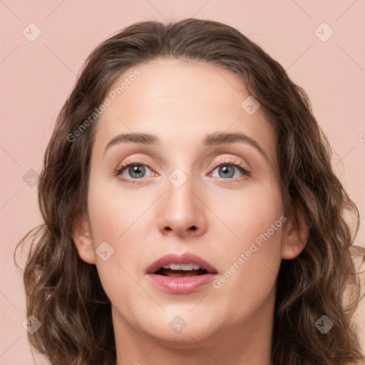 Joyful white young-adult female with medium  brown hair and green eyes