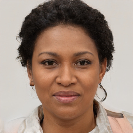 Joyful black adult female with short  brown hair and brown eyes
