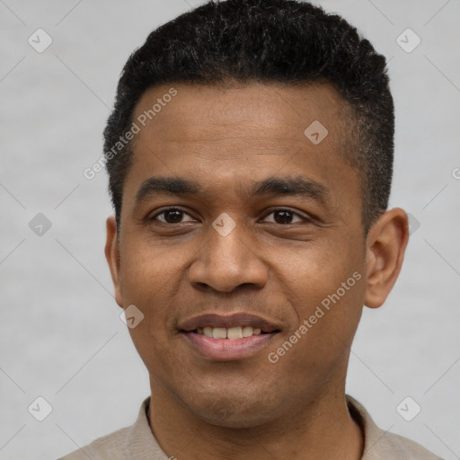 Joyful black young-adult male with short  black hair and brown eyes