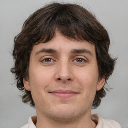 Joyful white young-adult male with medium  brown hair and brown eyes