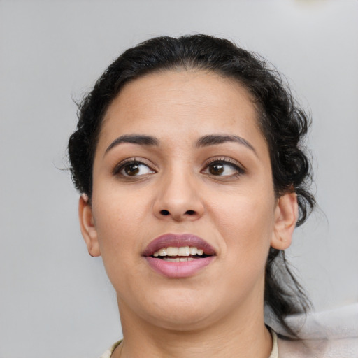Joyful latino young-adult female with medium  brown hair and brown eyes
