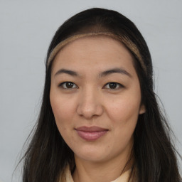 Joyful asian young-adult female with long  brown hair and brown eyes