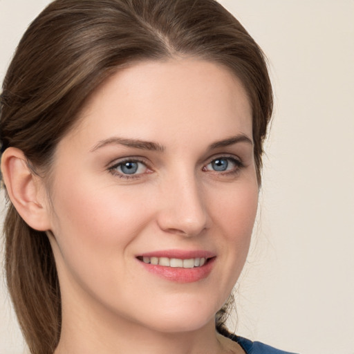 Joyful white young-adult female with medium  brown hair and blue eyes