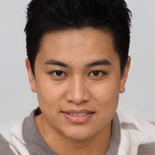 Joyful asian young-adult male with short  brown hair and brown eyes