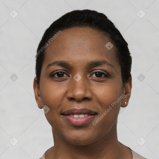 Joyful black young-adult female with short  black hair and brown eyes