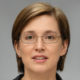 Joyful white adult female with medium  brown hair and blue eyes