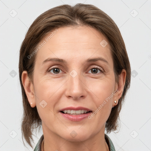 Joyful white adult female with medium  brown hair and grey eyes