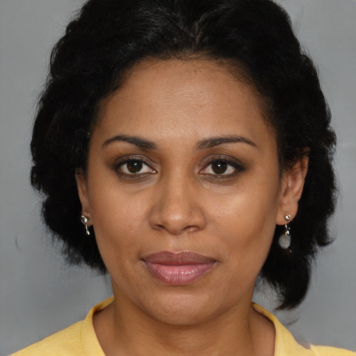 Joyful latino adult female with short  brown hair and brown eyes