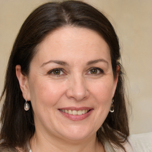 Joyful white adult female with medium  brown hair and grey eyes