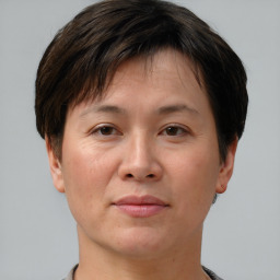 Joyful white adult female with short  brown hair and brown eyes