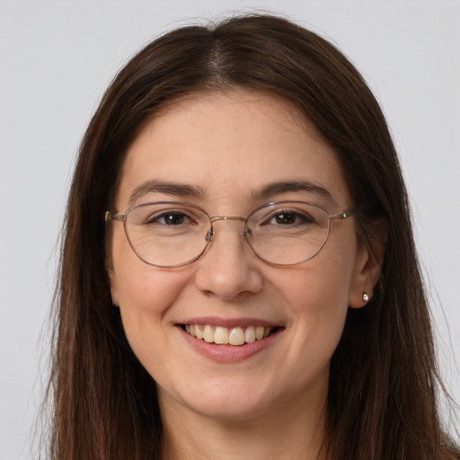 Joyful white adult female with long  brown hair and brown eyes