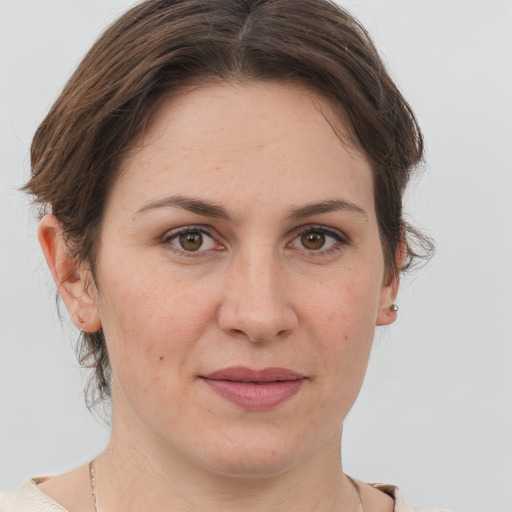 Joyful white young-adult female with short  brown hair and grey eyes