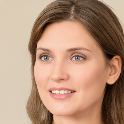 Joyful white young-adult female with long  brown hair and green eyes