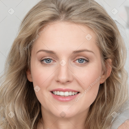 Joyful white young-adult female with long  brown hair and blue eyes