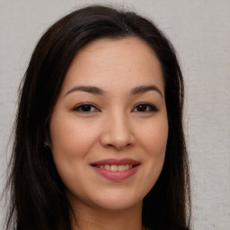 Joyful asian young-adult female with long  brown hair and brown eyes