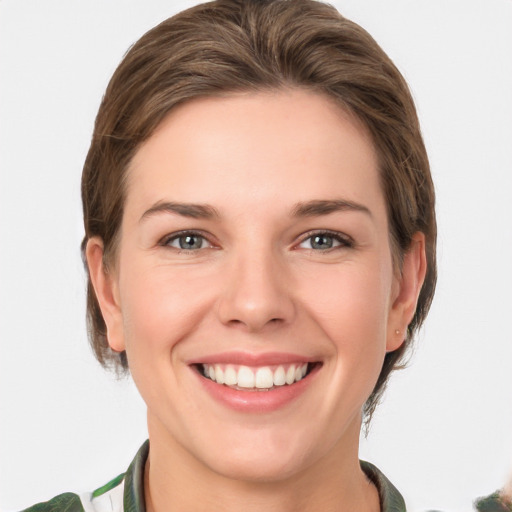 Joyful white young-adult female with medium  brown hair and green eyes