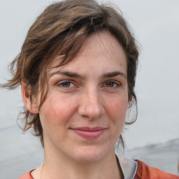 Joyful white adult female with medium  brown hair and grey eyes