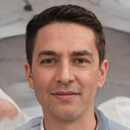 Joyful white adult male with short  brown hair and brown eyes