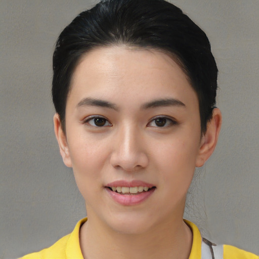 Joyful asian young-adult female with short  black hair and brown eyes