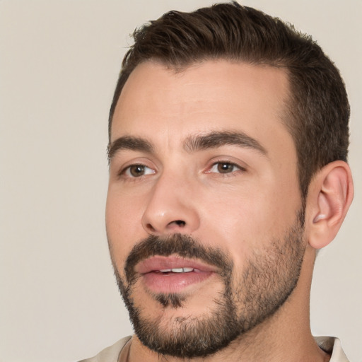 Joyful white young-adult male with short  brown hair and brown eyes