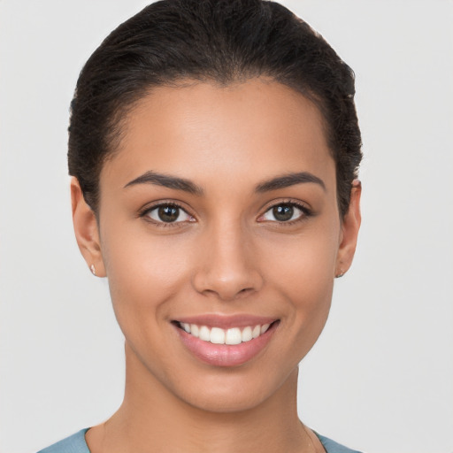 Joyful latino young-adult female with short  brown hair and brown eyes