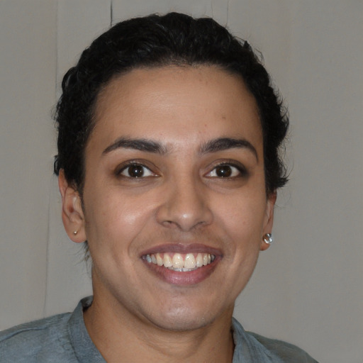 Joyful latino young-adult female with short  brown hair and brown eyes