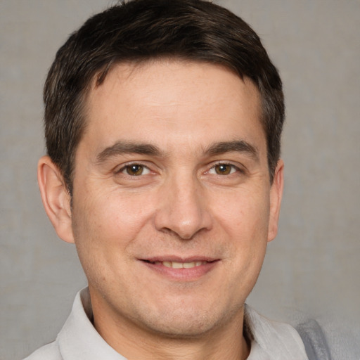 Joyful white adult male with short  brown hair and brown eyes