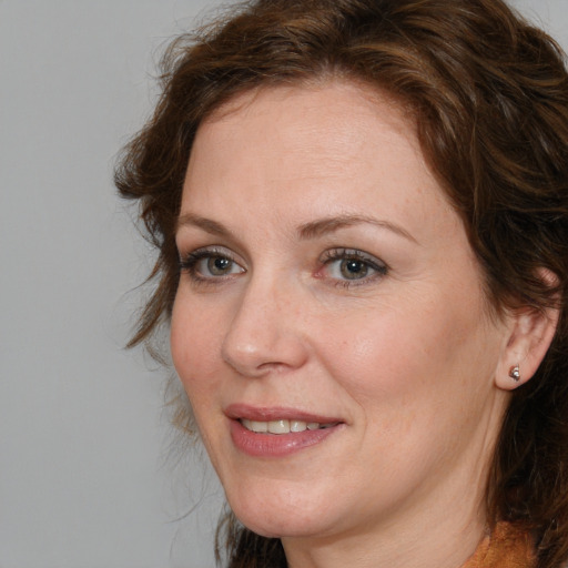 Joyful white adult female with long  brown hair and brown eyes