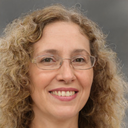 Joyful white adult female with medium  brown hair and green eyes