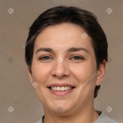 Joyful white adult female with short  brown hair and brown eyes