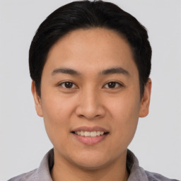 Joyful asian young-adult male with short  black hair and brown eyes