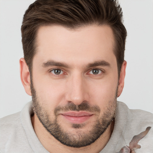 Joyful white young-adult male with short  brown hair and brown eyes