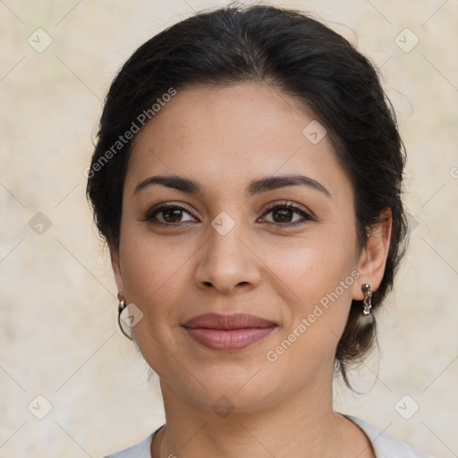 Joyful latino young-adult female with medium  brown hair and brown eyes