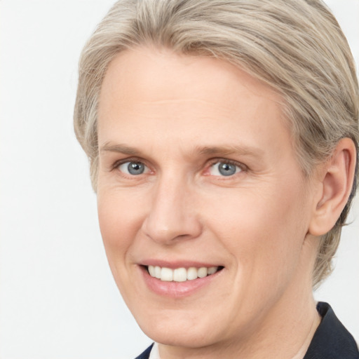 Joyful white adult female with medium  brown hair and grey eyes