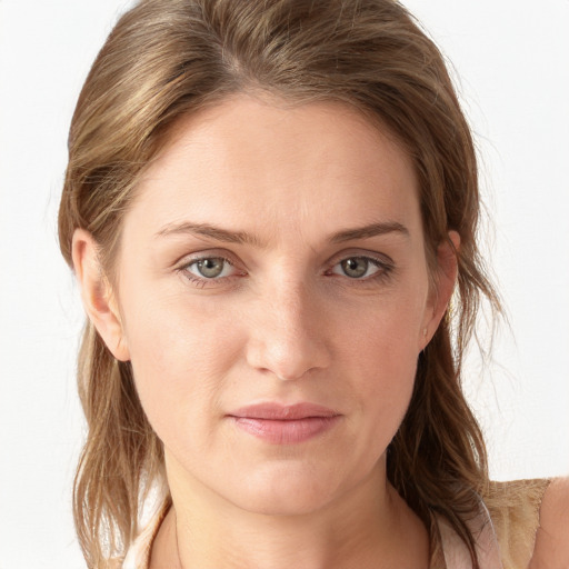 Joyful white young-adult female with long  brown hair and blue eyes