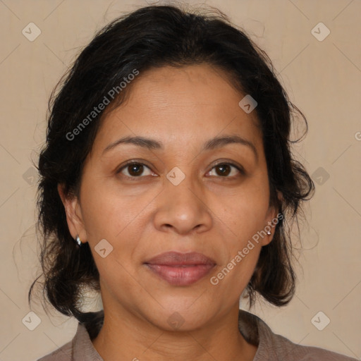 Joyful latino adult female with medium  brown hair and brown eyes