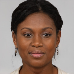 Joyful black young-adult female with medium  brown hair and brown eyes