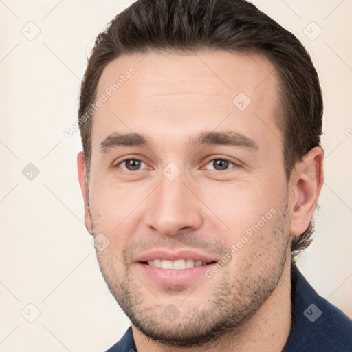 Joyful white young-adult male with short  brown hair and brown eyes