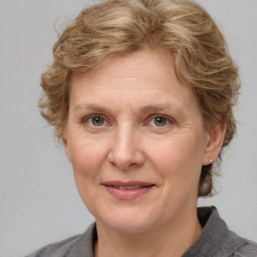 Joyful white adult female with medium  brown hair and grey eyes