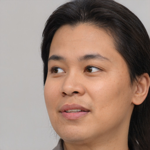 Joyful asian young-adult female with medium  brown hair and brown eyes